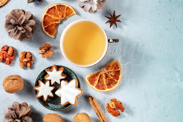 Wall Mural - Christmas flat lay composition with tea, biscuits, spices, dried oranges, and a place for text, shot from above. Sustainable winter holidays concept