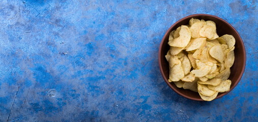 Potato Chips on an old wooden table. Close up food photo