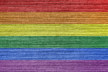 Rainbow LGBTQ or gay pride flag on scratched metal texture. Abstract background.