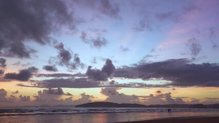 Wall Mural - Color blue and yellow sky after sunset and Cloudscape over the sea, Couple walking on beach, Romantic couple love, Nature Landscape, Seascape background  