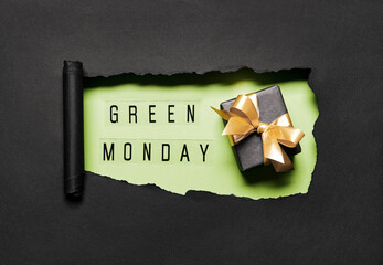 Green Monday text on green hole background with black gift box and golden bow. Shopping Discount promotion