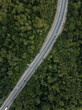 Aerial top down view of road in forest in mountains. Cars driving on highway in the woods. Summer landscape. Auto trip, Krasnodar krai Russia.