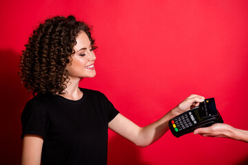 Sticker - Photo of cute adorable curly woman wear casual black outfit paying purchases credit card atm terminal isolated red color background