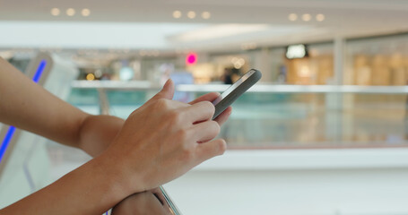 Poster - Woman use of mobile phone at shopping mall