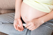 © sosiukin - woman hand holding pills for improve of iron level in blood. Receiving vitamins in pregnancy time, Healthy millennial healthcare concept