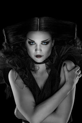 Wall Mural - Portrait of beautiful glamour woman in witch costume and creative makeup, black and white image with local color in the iris and lips