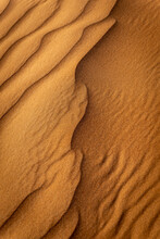 Closeup Of A Desert Dune With Orange Sand And Structure Of The Sand And Nature In Portrait Format 