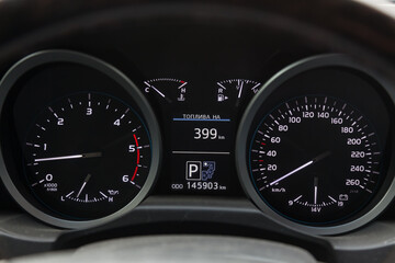 Wall Mural - The dashboard of the car is glowing white with arrows at night with a speedometer, charge battery level and volume of oil in the engine to monitor the condition in modern style on black isolated.