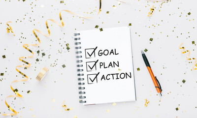Canvas Print - Notebook With Words Goal, Plan And Action Over White Background
