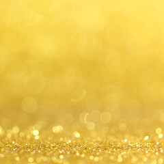 Wall Mural - gold festive christmas background. abstract twinkled bright background with bokeh defocused golden l
