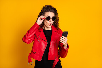 Sticker - Portrait of attractive cheery amazed wavy-haired girl using device browsing app web isolated on bright yellow color background