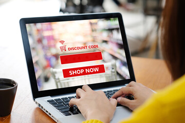 Hand typing discount coupon code on laptop computer screen to get the shopping online sale promotion, online shopping , digital marketing business and technology, lifestyle concept