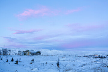 Wall Mural - Natural winter landscape of a house in the middle of a snowy field in iceland