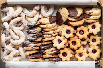 Top view of box full of German Christmas cookies baked in the delicious traditional home-made style of grandma. Horizontal close-up