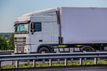 Wall Mural - Large White Truck Semi Trailer Drives On A Country Highway.