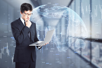 Wall Mural - Businessman thinks with laptop in hand on the background of financial charts, forex concept