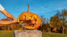 CLOSE UP: Halloween Pumpkin With Scared Face Getting Smashed With Baseball Bat