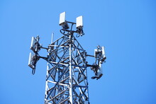Telecommunication Tower Of 4G And 5G Cellular. Macro Base Station. 5G Radio Network Telecommunication Equipment With Radio Modules And Smart Antennas Mounted On A Metal. 