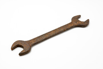 Old and rusty wrench on white isolated background