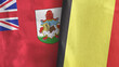 Belgium and Bermuda two flags textile cloth 3D rendering