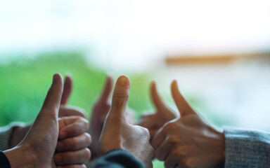 Canvas Print - A group of people making thumb up hands sign in circle