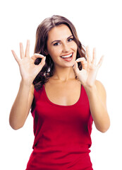 Wall Mural - Woman showing okay gesture, on white