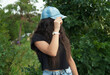 © ANAHIT - Young girl wearing a jeans cap, outdoors.