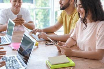 Canvas Print - Students with modern devices studying online indoors