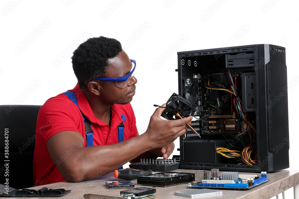 African-American technician repairing computer on white background