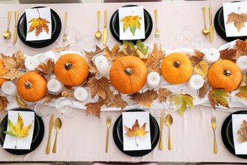 Wall Mural - Beautiful table setting with pumpkins and autumn leaves in dining room