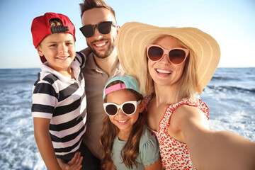 Poster - Happy family taking selfie on beach near sea. Summer vacation