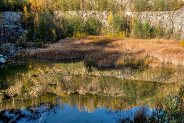 Wall Mural - Beautiful reflection of autumn colored trees in water, landscape of abandoned and flooded s,all quarry, Czech Republic