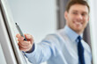 © Syda Productions - business, people and statistics concept - close up of businessman with scheme on flip chart at office