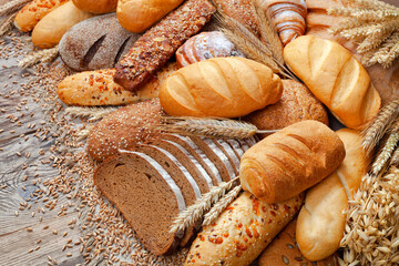 Wall Mural - Bakery product assortment with bread and buns on wooden table