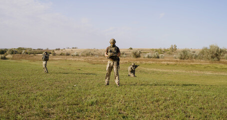 Soldiers protecting commander while surveilling enemy territory