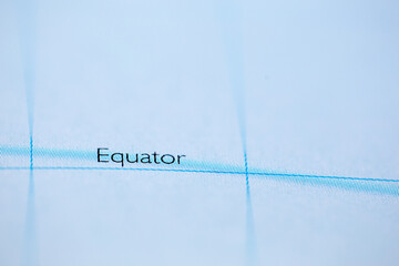 shallow depth of field focus on geographical map location of equator line on atlas