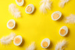 © Atlas - Boiled eggs and feathers on yellow background, top view