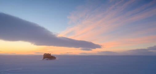 Wall Mural - winter arctic panoramic landscape. all-terrain vehicle drives on snow-covered tundra in the remote w
