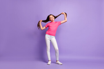 Sticker - Full length body size photo of smiling schoolgirl holding long brunette hair wearing casual clothes isolated on purple color background