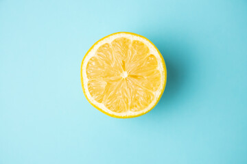 open lemon fruit on blue background