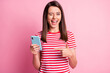 © deagreez - Photo portrait of girl keeping pointing at smartphone winking blinking isolated on pastel pink color background
