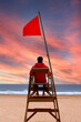 © Gelpi - Lifeguard sitting on a high chair looking at the sea