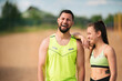 © Georgii - Laughing athletic couple in stylish sportswear resting after workout outdoor