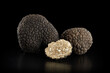 Black truffles group and slice on black, clipping path included