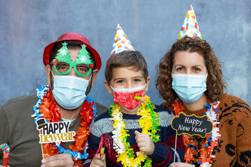 Happy family with face masks celebrating new years eve