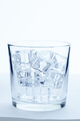 Sticker - glass with ice cubes on white background