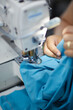© Yaar - The worker is sewing a textile with a sewing machine in a fabric factory.