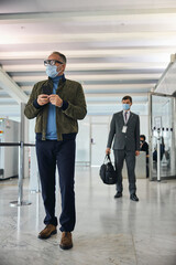 Wall Mural - Male tourist standing at the airport terminal