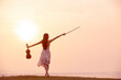 © ittipol - woman playing violin at sunset background