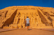 © unai - A young man walking towards the Abu Simbel Temple in southern Egypt in Nubia next to Lake Nasser. Temple of Pharaoh Ramses II, travel lifestyle
